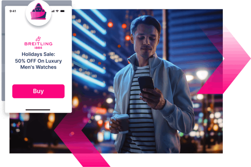 A man stands outdoors at night in a city, holding a coffee cup and looking at his phone. An online ad offers 50% off luxury men's watches from Breitling—reminding him to stay alert for scams and use Digital Impersonation protection.